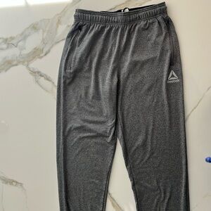 Men’s Reebok size small gray joggers, zippers at ankles, two zipper side pockets